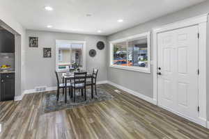 Dining space with a textured ceiling, recessed lighting, wood finished floors, and visible vents