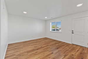 Unfurnished room featuring recessed lighting, baseboards, and light wood-style floors