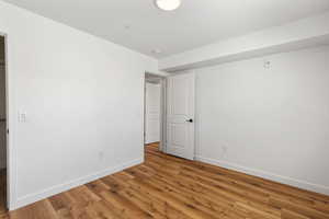Unfurnished bedroom with baseboards and light wood-type flooring