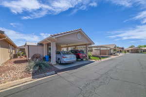 View of car parking featuring a residential view and an attached carport