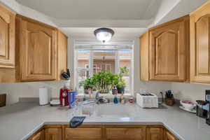 Kitchen featuring light countertops and a sink