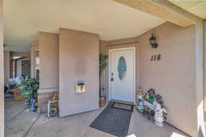 Property entrance featuring stucco siding