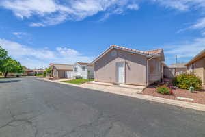 View of front of home with a residential view, stucco siding, and a tile roof