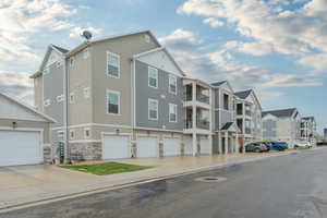 View of building exterior with a residential view and a garage