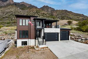 Modern 2-story home featuring stone and stucco, 3 car garage, with brilliant view of Willard Bay from the front balcony.