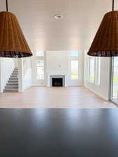 Unfurnished living room with baseboards, plenty of natural light, and a fireplace