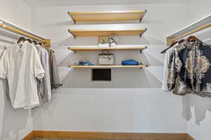 View of primary walk in closet