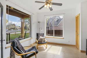 Office/den, a ceiling fan, hardwood / wood-style floors, and a wealth of natural light