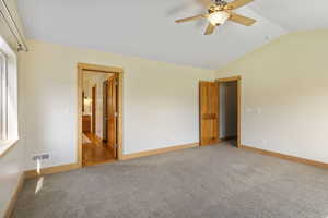 Primary Bedroom ensuite bathroom, light colored carpet, and vaulted ceiling