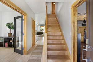 Main front door entry Staircase entry featuring hardwood / wood-style flooring