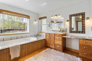 Primary Full bathroom featuring vanity, a bath, and hardwood / wood-style floors