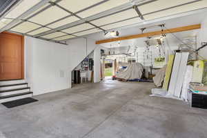 Deep heated garage with a back garage door, bike hoists, abundance of storage, sink, hose valve