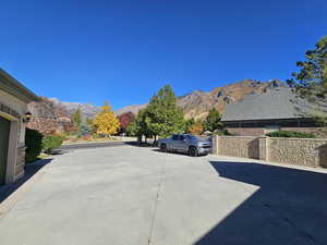 View of road featuring a mountain view and concrete driveway