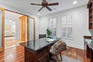 Office space with a ceiling fan, crown molding, arched walkways, recessed lighting, and light wood-style flooring