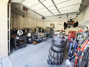 Garage featuring a workshop area and a garage door opener