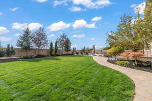View of home's community featuring fence and a yard