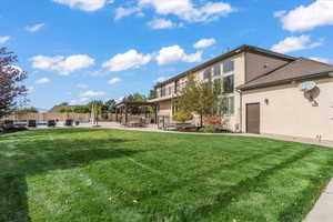 View of yard featuring fence, a fenced in pool, a gazebo, and a patio area