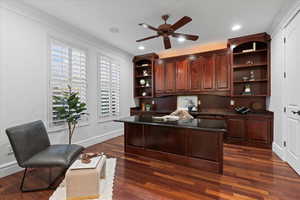Home office featuring built in study area, baseboards, ceiling fan, dark wood-style floors, and recessed lighting