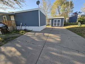 Back of property featuring an outbuilding and a storage unit
