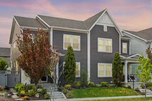View of front facade featuring a yard and covered porch
