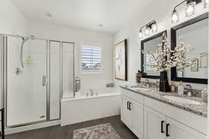 Full bathroom with a sink, a bath, and a shower stall
