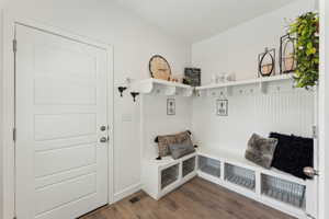 Mudroom featuring visible vents and wood finished floors