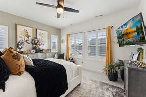 Bedroom featuring baseboards, ceiling fan, carpet, and visible vents