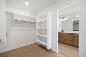 Primary Closet.   Photo is of a Completed Willow Plan in a Different Location.  Options and Colors will Vary.