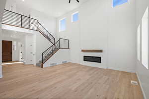 Great Room with Metal Railing and Fireplace.   Photo is of a Completed Willow Plan in a Different Location.  Options and Colors will Vary.