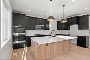 Double Oven and Gas Cooktop.  Large Island.   Photo is of a Completed Willow Plan in a Different Location.  Options and Colors will Vary.