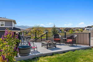 Deck with a residential view, a mountain view, and an outdoor fire pit
