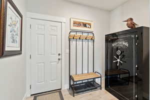 Mudroom with light wood-type flooring and baseboards
