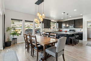 Dining space with recessed lighting, light wood-style flooring, baseboards, and visible vents
