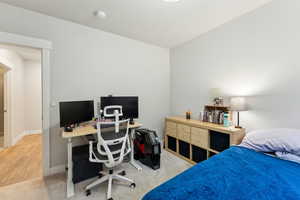 Carpeted bedroom featuring baseboards