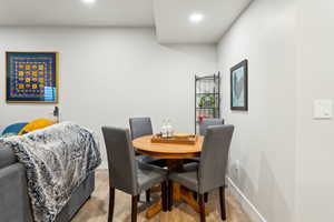Dining room with recessed lighting, baseboards, and light wood finished floors