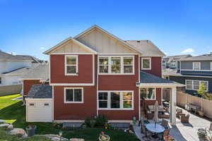Back of house featuring board and batten siding, fence, outdoor lounge area, and a patio area
