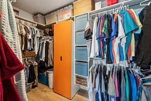 Spacious closet with wood finished floors