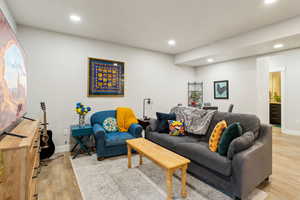 Living area featuring recessed lighting, baseboards, and light wood-type flooring