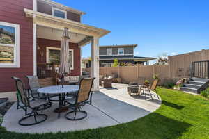 View of patio / terrace featuring an outdoor living space with a fire pit and fence