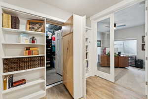 Interior space with a ceiling fan and light wood finished floors