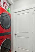 Washroom featuring laundry area and stacked washer and dryer