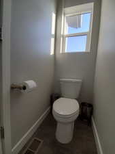 Full primary ensuite featuring a subway tile stamped insert double vanity with undermount sinks, wide baseboards and vinyl flooring