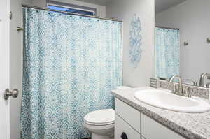 Full bathroom featuring shower/tub combo with toilet and a single sink vanity with drawers and cabinet space. There is also a full linen closet next to this bathroom in the hallway with plenty of storage space.
