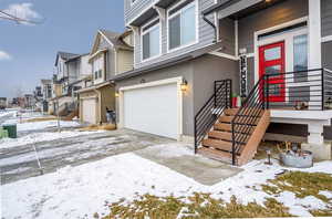Exterior space with a garage, stucco siding, front porch and a residential view