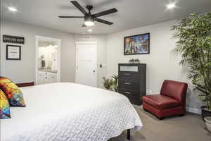 Large primary bedroom with ample space for seating area features cut and loop carpet, wide baseboards, recessed lighting, ceiling fan with light, large walk-in closet and a beautiful spa style ensuite.