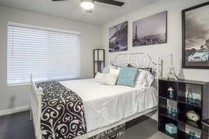 Bedroom #3 featuring large window with custom fit vinyl blinds, cut and loop carpet, ceiling fan with light, ample closet space and wide baseboards