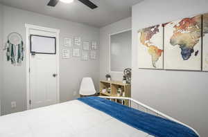 Bedroom #2 featuring large window with custom fit vinyl blinds, cut and loop carpet, ceiling fan with light, ample closet space and wide baseboards