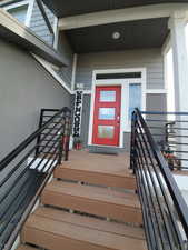 Welcoming property entrance with 3 glass pane red door.