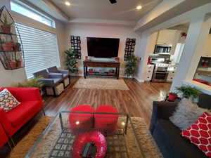 Spacious living room and kitchen with beautiful mountain views and plenty of natural light coming from the extra large windows and hi window package. Also features wide baseboards, ceiling fan, recessed lighting, and LVP flooring.  ALL WINDOW COVERINGS IN