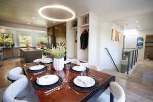 Dining room with recessed lighting and light wood-type flooring